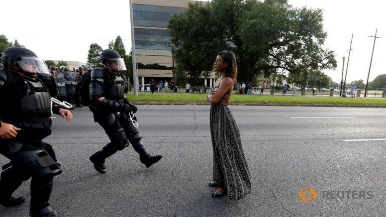 Police charging at unarmed protester.