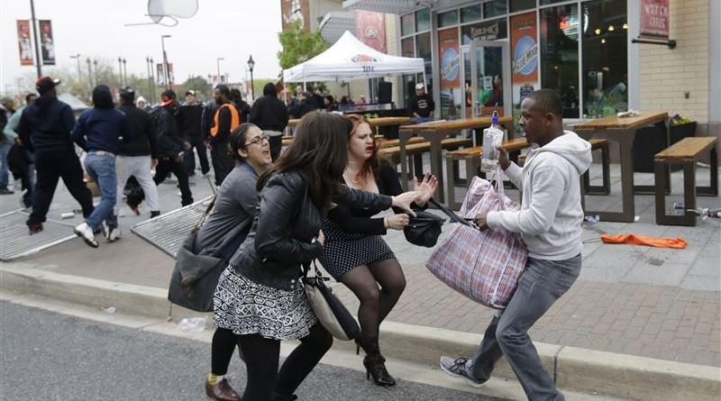  A protester snatching a bag from innocent citizens.